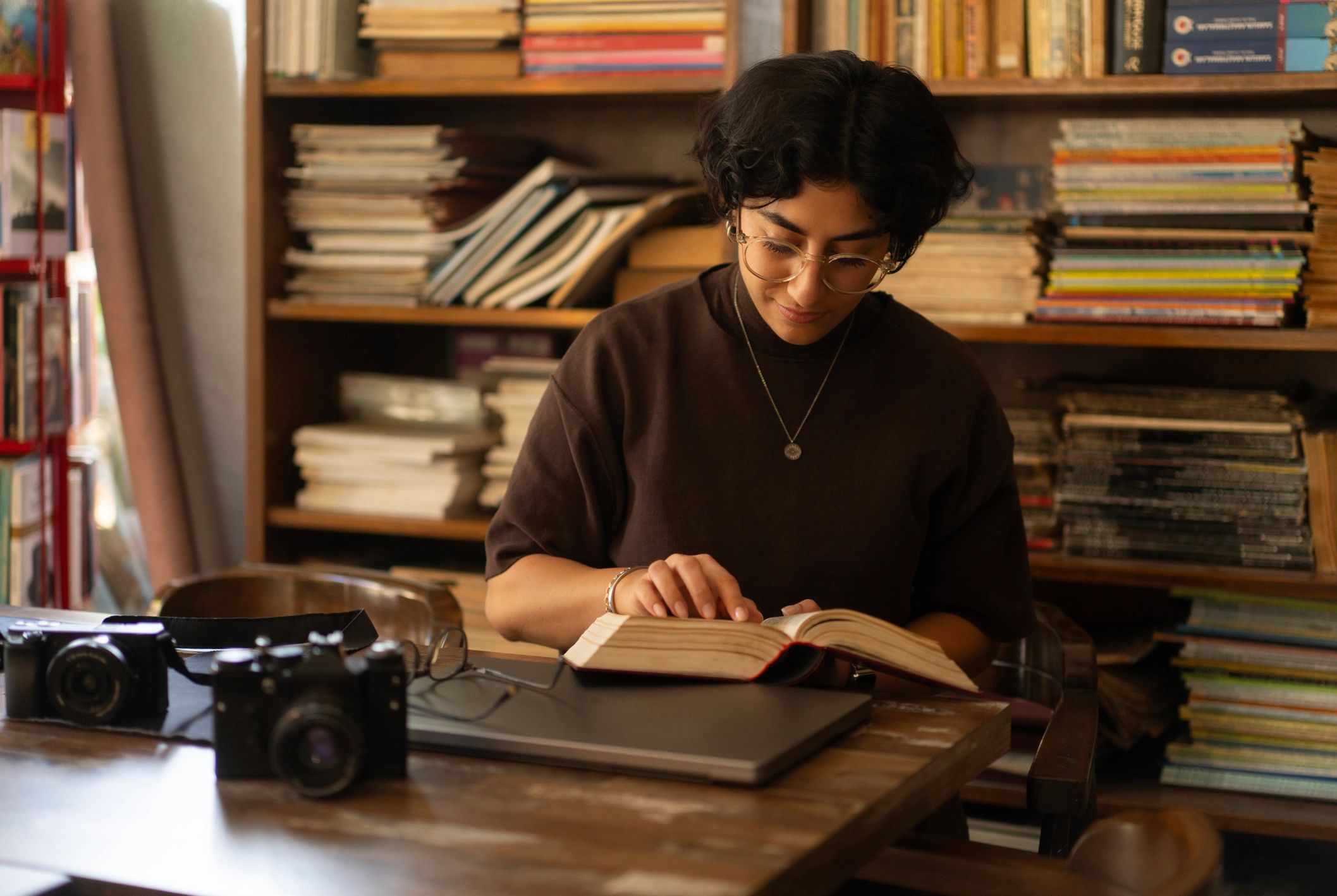 Editor reviewing a book in a library setting